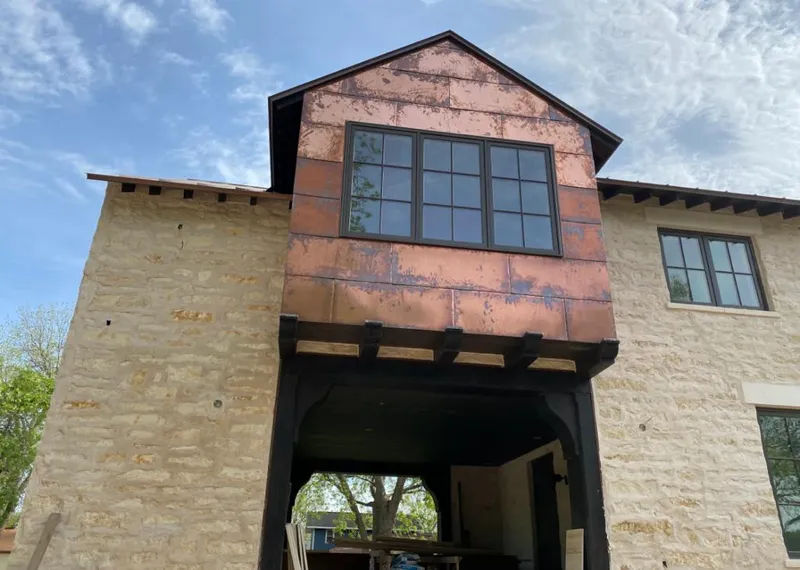 Copper metal panel facade on a stone building for Skylight Installation in Alamo